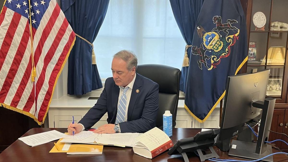 Dr. Joyce at his desk, reviewing a letter